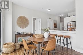 Oshawa (O'neill) condo for rent - A modern dining room with a round table and chairs.