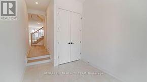 Ottawa apartment for rent - A white door is closed in a room with a staircase in the background.