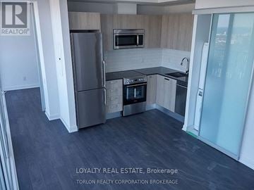 Toronto (Church-Yonge Corridor) condo for rent - A kitchen with a refrigerator, oven, and microwave.