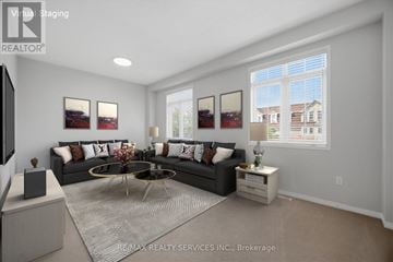 Mississauga (Churchill Meadows) apartment for rent - A modern living room with a large sectional sofa and a coffee table in the center.