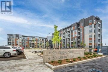 Oakville (Go Glenorchy) condo for rent - A modern apartment complex with a sign in front that reads "905 Dundas Street" and "50 Kaiting Trail".