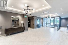 Oakville (Go Glenorchy) condo for rent - A spacious room with a wooden floor and a mirror on the wall.