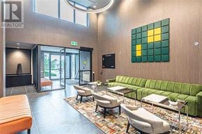 Oakville (Go Glenorchy) condo for rent - A living room with a green couch and a television.