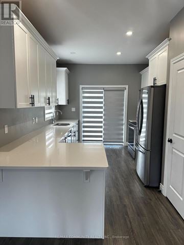 Belleville (Thurlow Ward) apartment for rent - A kitchen with white cabinets and a large island.