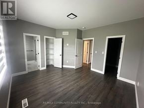 Belleville (Thurlow Ward) apartment for rent - A room with wooden floors and white walls, with a logo of RE/MAX Community Realty Inc. in the bottom left corner.