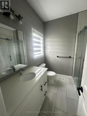 Belleville (Thurlow Ward) apartment for rent - A bathroom with a toilet, sink, and mirror.