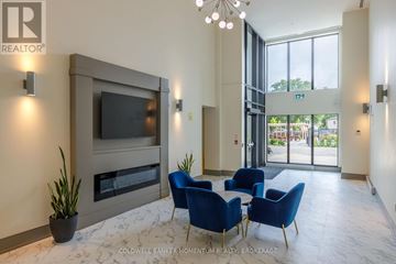 St. Catharines (Oakdale) condo for rent - A living room with blue chairs and a television.