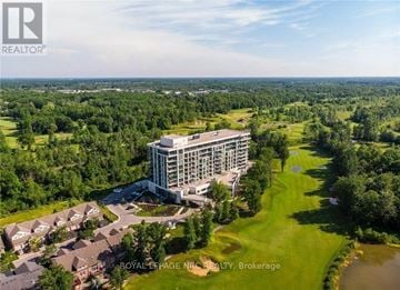 Niagara Falls (Oldfield) condo for rent - A bird's eye view of a real estate property with a large building and several houses.