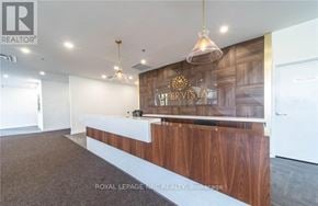 Niagara Falls (Oldfield) condo for rent - A reception area with a wooden counter and a sign that reads "PERVISTA".