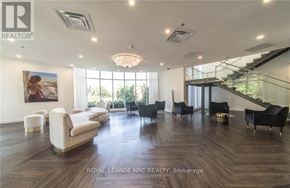 Niagara Falls (Oldfield) condo for rent - A spacious living room with a staircase and a painting on the wall.