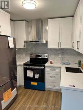 Toronto (Annex) apartment for rent - A kitchen with a refrigerator, oven, and cabinets.