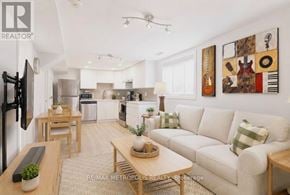 Oshawa (Donevan) apartment for rent - A living room with a couch, a coffee table, and a television.
