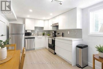Oshawa (Donevan) apartment for rent - A modern kitchen with white cabinets and stainless steel appliances.