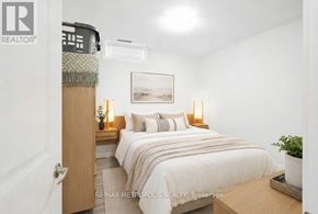 Oshawa (Donevan) apartment for rent - A bedroom with a bed, nightstands, and a plant.