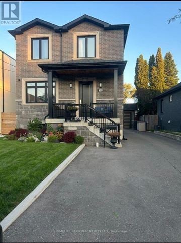Mississauga (Lakeview) apartment for rent - A house with a grey front yard and a black gate.