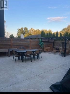 Mississauga (Lakeview) apartment for rent - A backyard with a table and chairs.