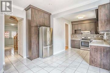 Markham (Middlefield) apartment for rent - A kitchen with a refrigerator, oven, and sink.