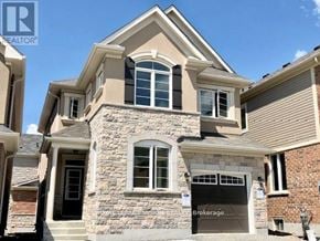 Pickering apartment for rent - A house with a stone facade and a garage door labeled Brokerage.