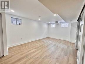 Pickering apartment for rent - A spacious room with wooden flooring and white walls.