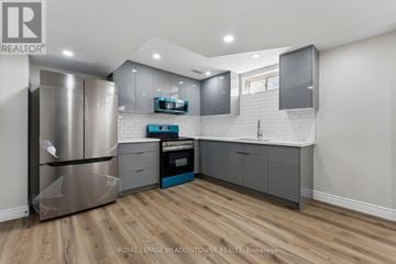 Caledon apartment for rent - A kitchen with a stainless steel refrigerator and wooden flooring.