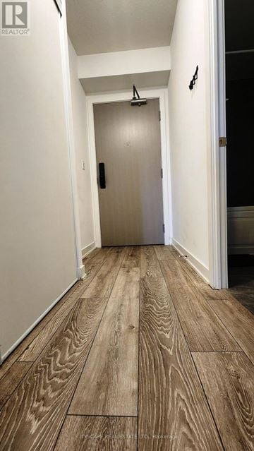 Burlington (Alton) condo for rent - A hallway with wood flooring and a white door.