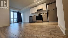 Burlington (Alton) condo for rent - A spacious kitchen with wooden flooring and modern appliances.
