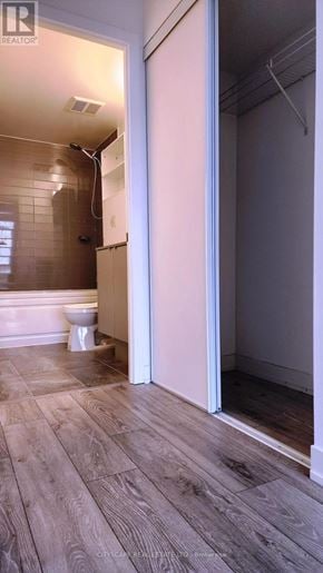 Burlington (Alton) condo for rent - A bathroom with a toilet and a shower.