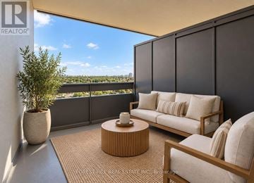 Toronto (Briar Hill-Belgravia) condo for rent - A living room with a couch, chair, and table with a view of the city.