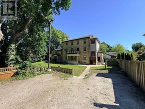 London East (East F) multi-family for rent - A house with a gravel driveway in front of it.