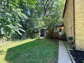 London East (East F) multi-family for rent - A backyard with a white fence and a green lawn.