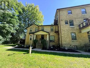London East (East F) multi-family for rent - A house with a front yard and a tree.