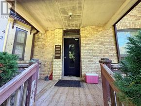 London East (East F) multi-family for rent - A black door is on the left side of a brick building.