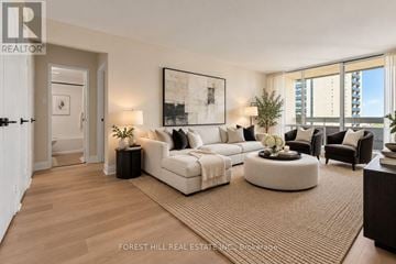 Toronto (Briar Hill-Belgravia) condo for rent - A living room with a large couch and a painting on the wall.