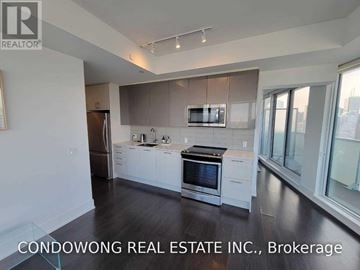 Toronto (Church-Yonge Corridor) condo for rent - A modern kitchen with white cabinets and stainless steel appliances.