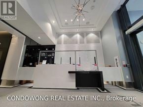 Toronto (Church-Yonge Corridor) condo for rent - A modern office lobby with a reception desk and a chandelier.