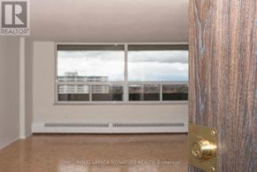 Toronto (Westminster-Branson) house for rent - A room with a door and a window overlooking a cityscape.