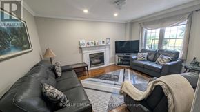 Vaughan (East Woodbridge) apartment for rent - A living room with a fireplace and a television.
