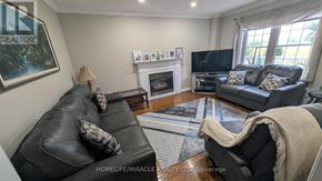 Vaughan (East Woodbridge) apartment for rent - A living room with a fireplace and a couch.