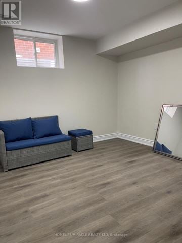 Mississauga (Hurontario) apartment for rent - A living room with a blue couch and a mirror on the wall.