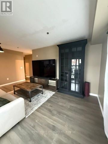 Brampton (Northwest Brampton) condo for rent - A living room with a white couch and a wooden coffee table.