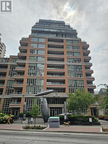 Toronto (Niagara) condo for rent - A tall building with a glass facade and a sculpture in front of it.