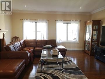 Richmond Hill apartment for rent - A living room with a brown leather couch and a glass coffee table.