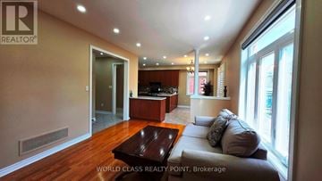Vaughan (Vellore Village) apartment for rent - A living room with a brown coffee table and grey couch.