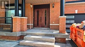 Vaughan (Vellore Village) apartment for rent - A red brick house with a black door and a sign that says "REALTOR".