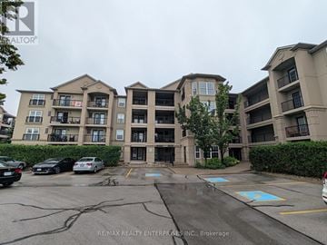 Burlington (Uptown) condo for rent - A parking lot in front of a building with a sign that says RE/MAX Realty Enterprises Inc., Brokerage.