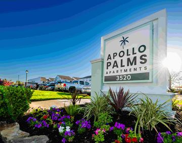 Seabrook apartment for rent - A sign for Apollo Palms Apartments stands in front of a flower bed.