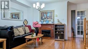 Vaughan (Sonoma Heights) apartment for rent - A living room with a black couch, a coffee table, and a fireplace.