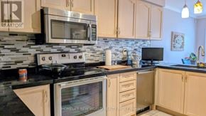 Vaughan (Sonoma Heights) apartment for rent - A kitchen with a stove top oven and microwave above it.