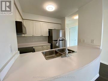 Toronto (Willowdale East) condo for rent - A kitchen with a sink and a refrigerator.