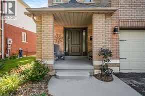 Waterdown apartment for rent - A house with a front yard and a covered entryway.
